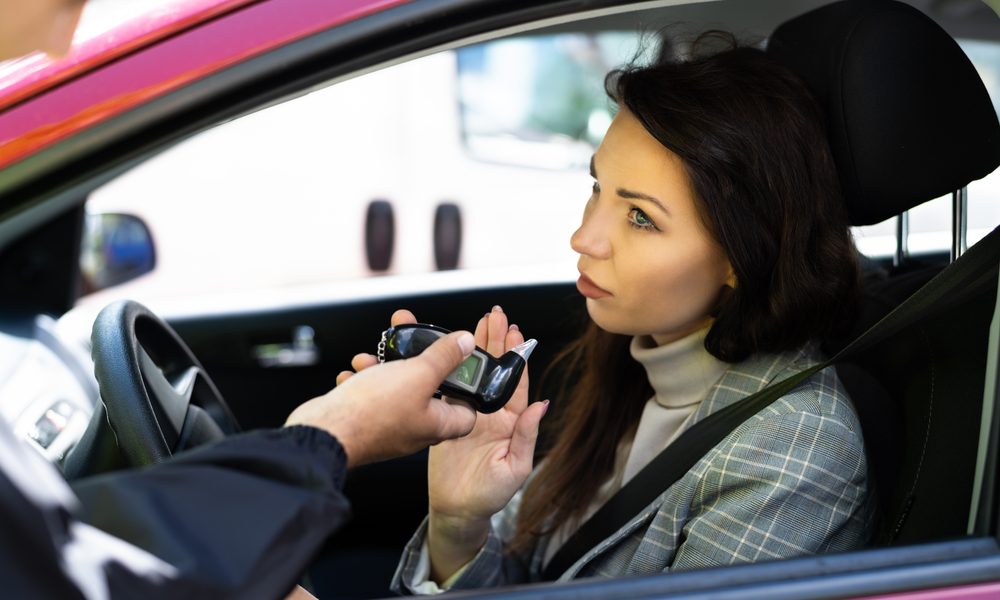 A woman arguing and refusing a breathalyzer test.