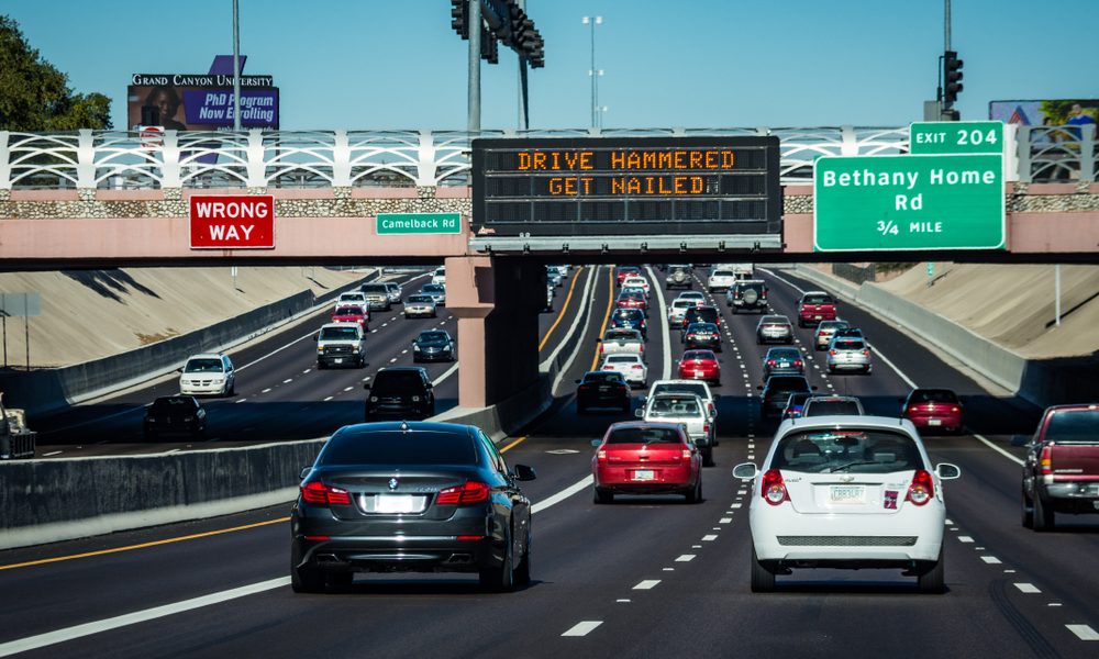 A highway in Tucson, Arizona, with an electronic sign warning against driving under the influence.