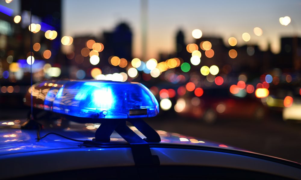 A police officer's siren with a bokeh background of Los Angeles behind it.