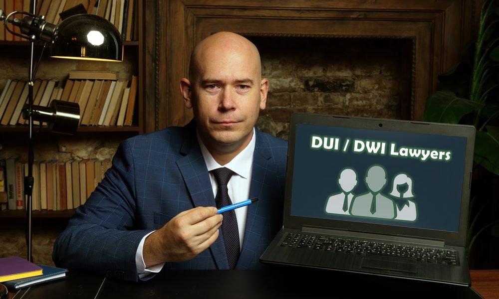 Business concept meaning DUI DWI Lawyers with sign on card in hand